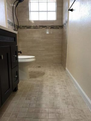 Brown tiled bathroom with accessible shower