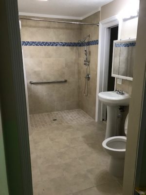 Open shower in tan bathroom